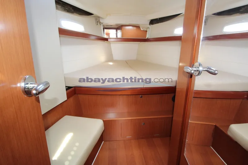  Yacht Photos Pics Interior cabin of 2007 Beneteau Oceanis 43 yacht with wooden finish and seating.