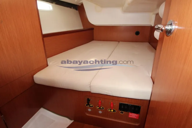  Yacht Photos Pics Cabin interior of 2007 Beneteau Oceanis 43 yacht with wooden finish and cozy bed.