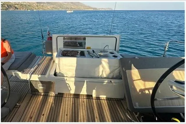  Yacht Photos Pics Jeanneau 60 yacht deck with outdoor kitchen, overlooking serene blue waters, 2021 model.