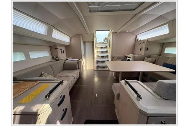  Yacht Photos Pics Interior of 2021 Jeanneau 60 yacht, featuring modern seating and dining area.