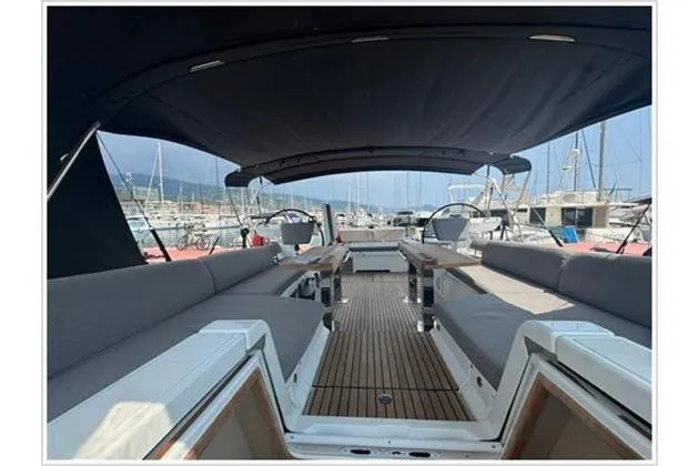  Yacht Photos Pics 2021 Jeanneau 60 yacht interior with spacious seating and elegant design in marina setting.