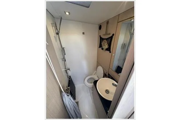  Yacht Photos Pics 2021 Jeanneau 60 yacht bathroom with modern fixtures and compact design.