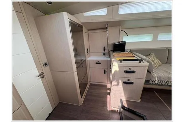  Yacht Photos Pics Modern interior of 2021 Jeanneau 60 yacht with sleek kitchen and seating area.