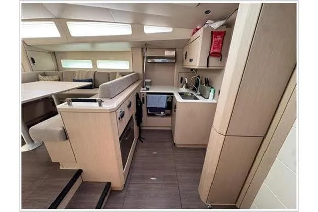  Yacht Photos Pics Modern interior of 2021 Jeanneau 60 yacht with kitchen and seating area.