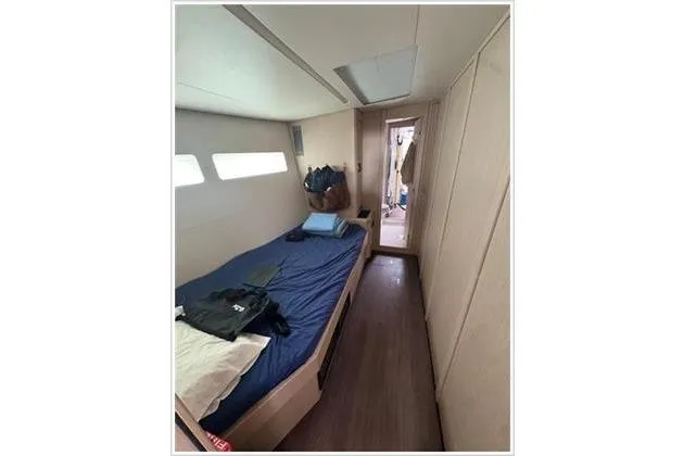  Yacht Photos Pics 2021 Jeanneau 60 yacht cabin with bed, modern interior, and natural light.