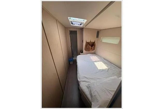  Yacht Photos Pics Luxurious cabin interior of 2021 Jeanneau 60 yacht with modern design and skylight.