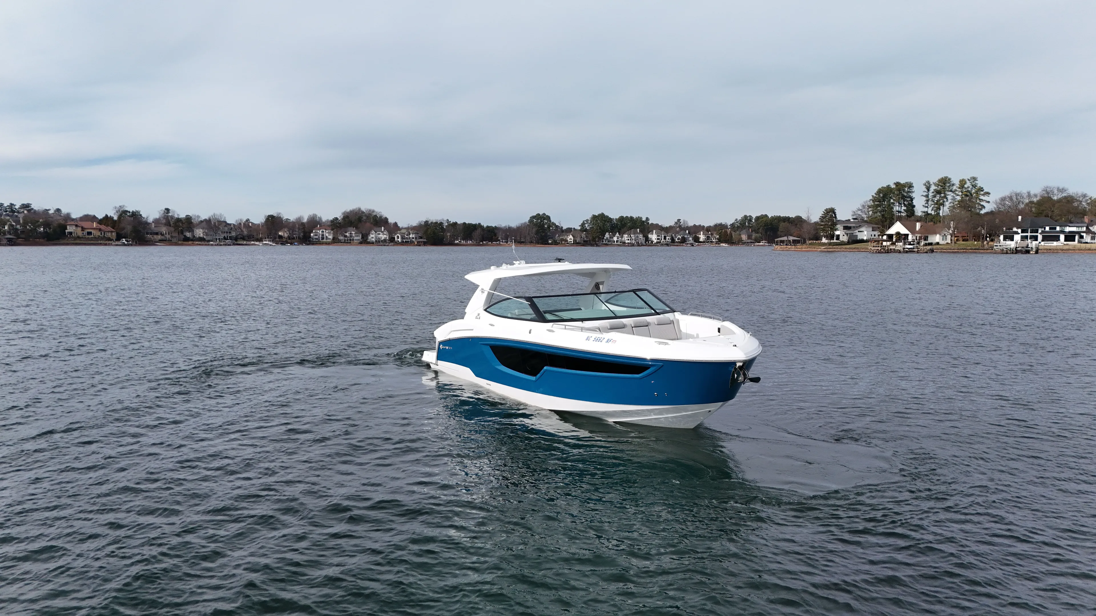  Yacht Photos Pics 2025 Cruisers Yachts 38 GLS on a serene lake.