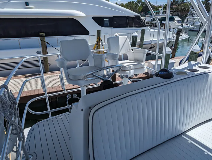 Rubia Yacht Photos Pics 2000 Luhrs 36 Convertible yacht with white seating and helm at marina.