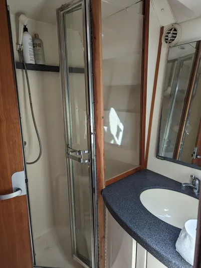 Rubia Yacht Photos Pics Bathroom interior of 2000 Luhrs 36 Convertible yacht with shower and sink.