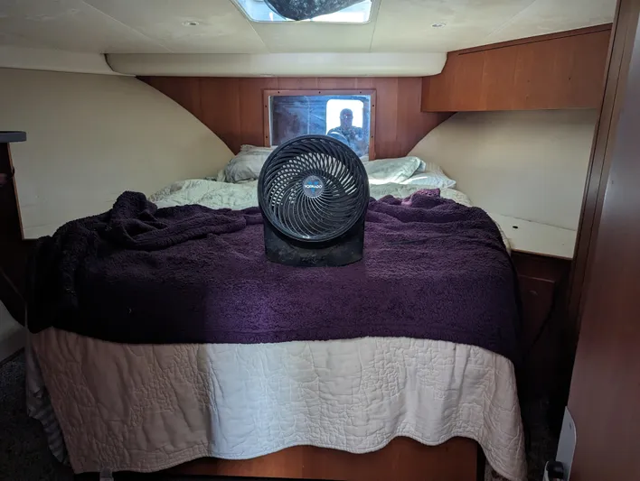 Rubia Yacht Photos Pics Luhrs 36 Convertible 2000 cabin interior with bed and fan.