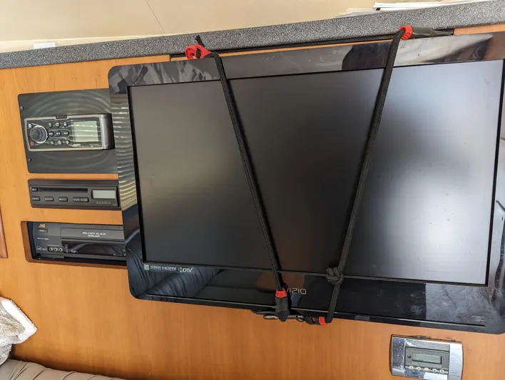 Rubia Yacht Photos Pics Entertainment system on a 2000 Luhrs 36 Convertible boat, featuring a secured flat-screen TV.