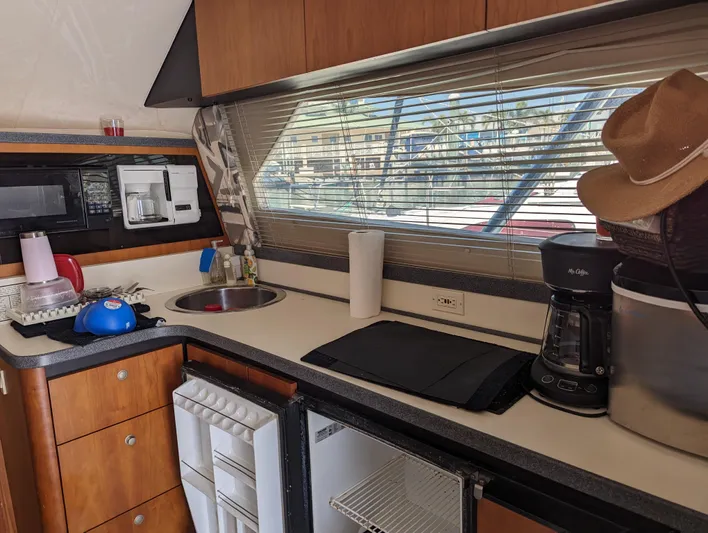 Rubia Yacht Photos Pics Luhrs 36 Convertible 2000 yacht kitchen with appliances and window view.