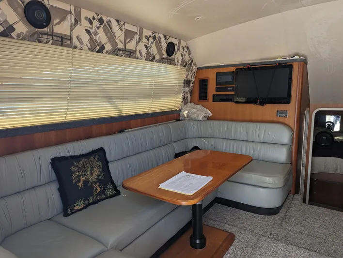 Rubia Yacht Photos Pics Interior of 2000 Luhrs 36 Convertible yacht with cozy seating and table.
