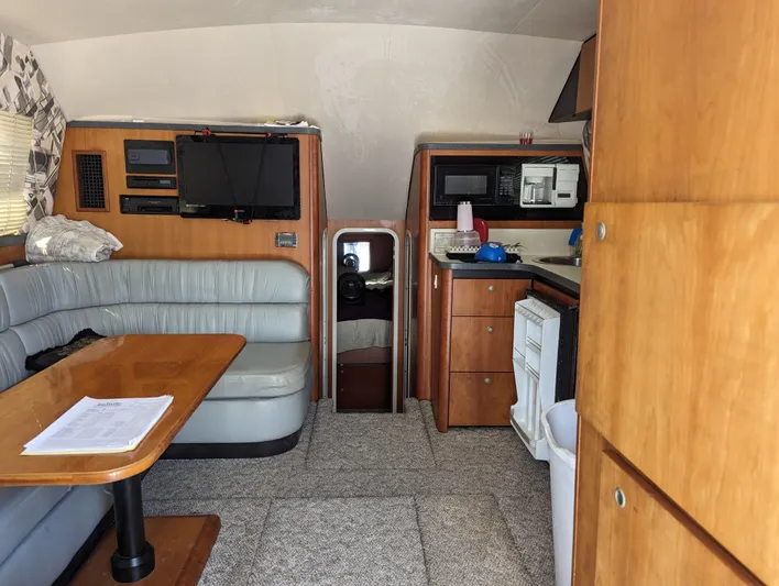 Rubia Yacht Photos Pics Interior of 2000 Luhrs 36 Convertible yacht with seating, table, and kitchenette.