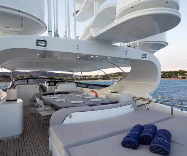  Yacht Photos Pics Luxurious 2009 Maiora 31DP yacht deck with elegant dining area and scenic ocean view.