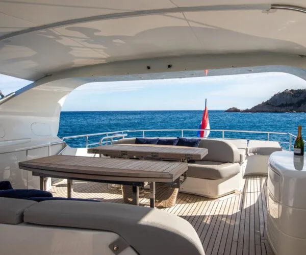  Yacht Photos Pics Luxurious 2009 Maiora 31DP yacht deck with seating, table, and ocean view.