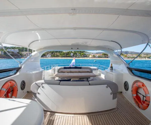  Yacht Photos Pics Luxurious 2009 Maiora 31DP yacht deck with seating, ocean view, and safety equipment.