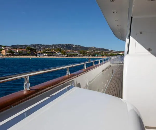  Yacht Photos Pics Luxury yacht Maiora 31DP (2009) cruising near scenic coastline under clear blue sky.