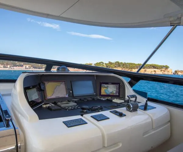  Yacht Photos Pics Helm of 2009 Maiora 31DP yacht with navigation equipment, overlooking scenic coastal waters.