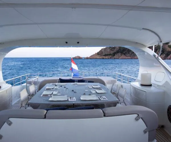  Yacht Photos Pics Luxurious 2009 Maiora 31DP yacht dining area with ocean view and elegant table setting.