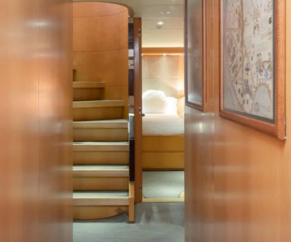  Yacht Photos Pics Interior of 2009 Maiora 31DP yacht featuring wooden stairs and cozy bedroom.