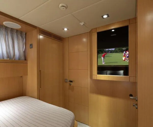  Yacht Photos Pics Luxurious Maiora 31DP yacht bedroom with TV, wood paneling, and cozy bed, 2009 model.