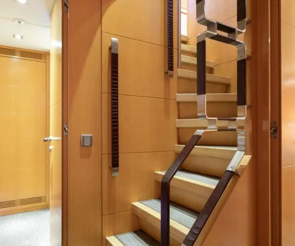  Yacht Photos Pics Luxurious wooden staircase inside 2009 Maiora 31DP yacht, featuring modern design elements.