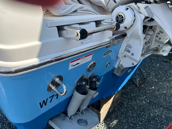  Yacht Photos Pics 2022 Sailfish 320 CC boat stern with motor and blue hull.