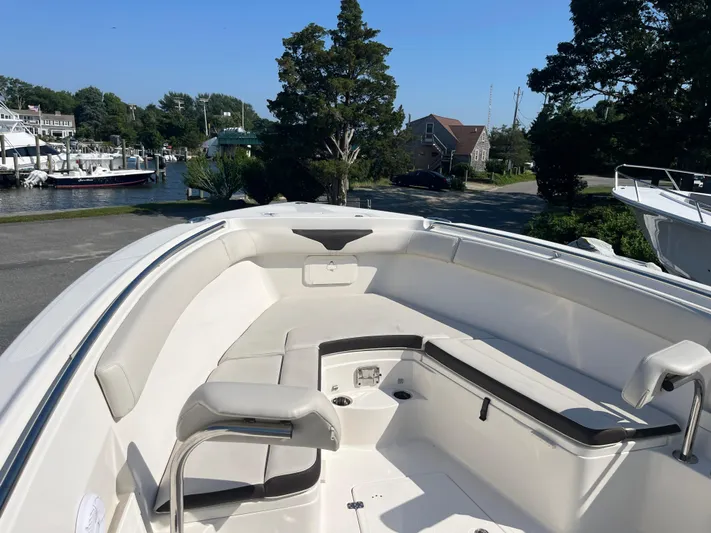  Yacht Photos Pics 2022 Sailfish 320 CC boat with spacious seating and scenic marina background.