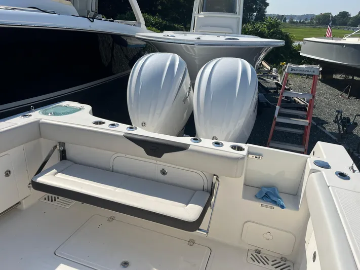  Yacht Photos Pics 2022 Sailfish 320 CC boat with twin outboard engines and foldable seating.