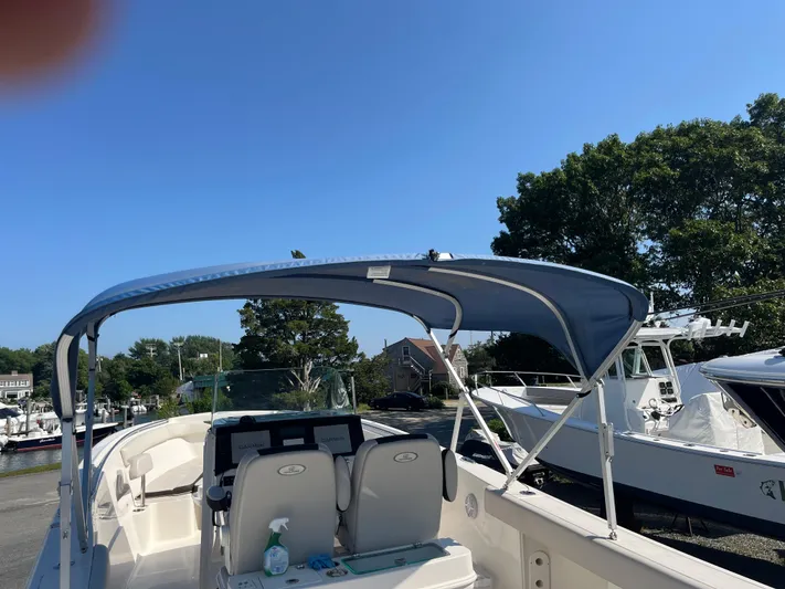  Yacht Photos Pics 2022 Sailfish 320 CC boat with blue canopy docked at marina.