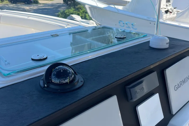  Yacht Photos Pics Control panel of 2022 Sailfish 320 CC boat with compass and Garmin electronics.