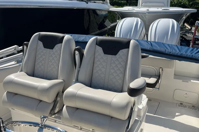  Yacht Photos Pics 2022 Sailfish 320 CC boat with dual cushioned seats and twin outboard motors.