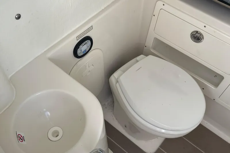 Yacht Photos Pics 2022 Sailfish 320 CC boat bathroom with toilet and sink.