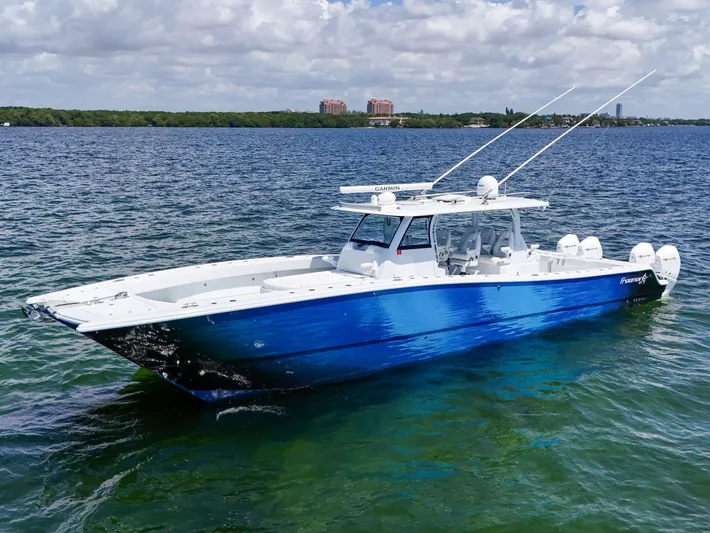  Yacht Photos Pics 2023 Freeman 47 boat on clear blue water under a partly cloudy sky.