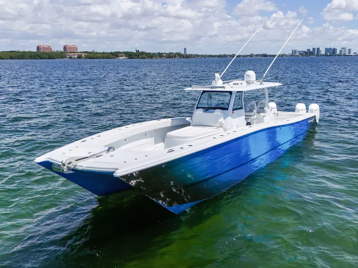  Yacht Photos Pics 2023 Freeman 47 boat on calm water, featuring a sleek blue and white design.