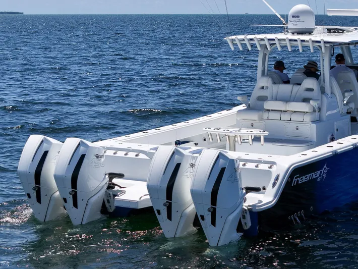  Yacht Photos Pics 2023 Freeman 47 boat with four powerful outboard engines on open water.