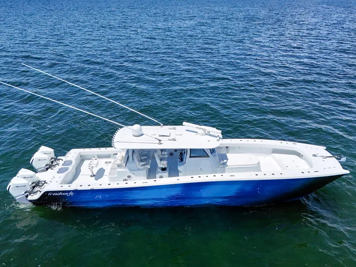  Yacht Photos Pics 2023 Freeman 47 boat on open water, featuring a sleek blue and white design.