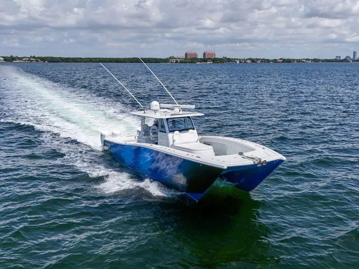  Yacht Photos Pics 2023 Freeman 47 boat cruising on open water under cloudy skies.