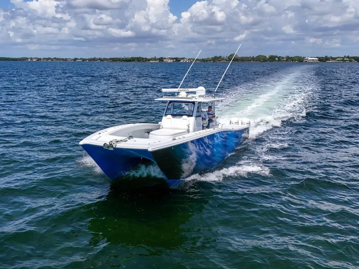  Yacht Photos Pics 2023 Freeman 47 boat cruising on open water under a partly cloudy sky.