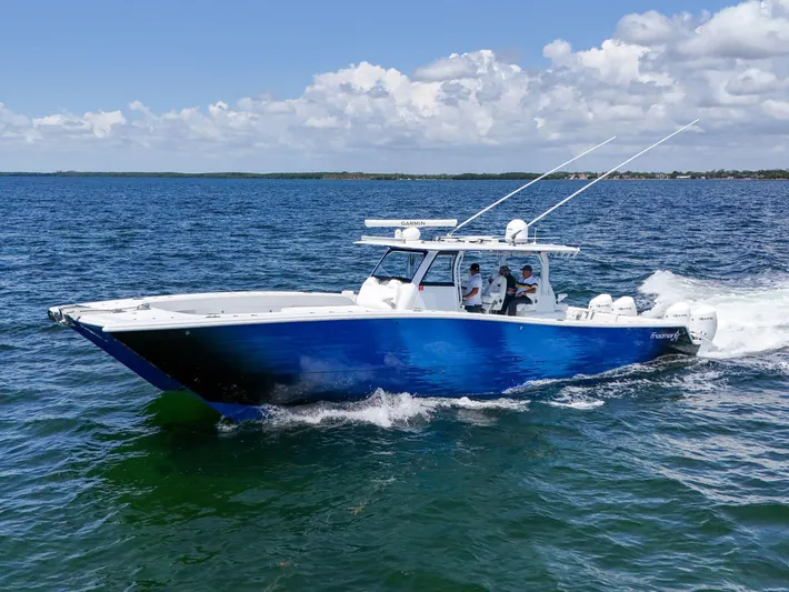  Yacht Photos Pics 2023 Freeman 47 boat cruising on open water under a partly cloudy sky.