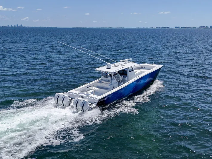  Yacht Photos Pics 2023 Freeman 47 boat cruising on open water with city skyline in background.