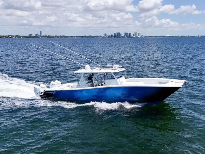  Yacht Photos Pics 2023 Freeman 47 boat cruising on open water under a partly cloudy sky.