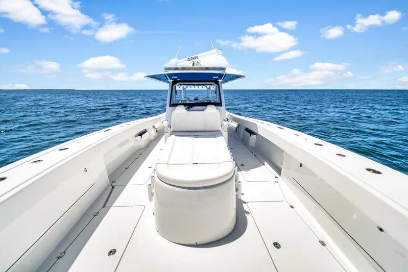  Yacht Photos Pics 2023 Freeman 47 boat on open sea under blue sky with clouds.