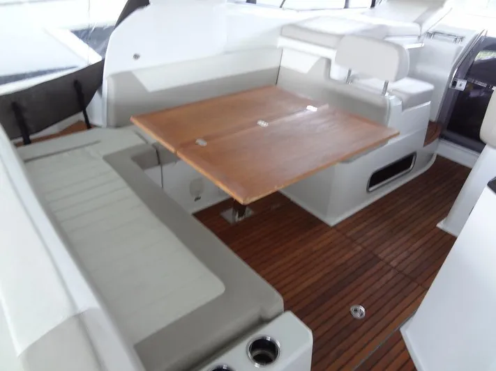 Lake Time, Austin, Tx Yacht Photos Pics 2017 Jeanneau LEADER 36 interior with wooden table and seating on teak flooring.