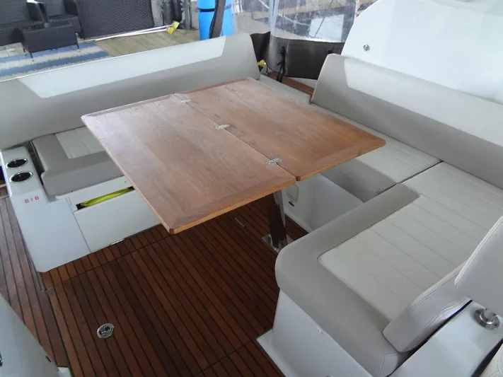 Lake Time, Austin, Tx Yacht Photos Pics Jeanneau LEADER 36 yacht interior, 2017 model, featuring a wooden table and cushioned seating.