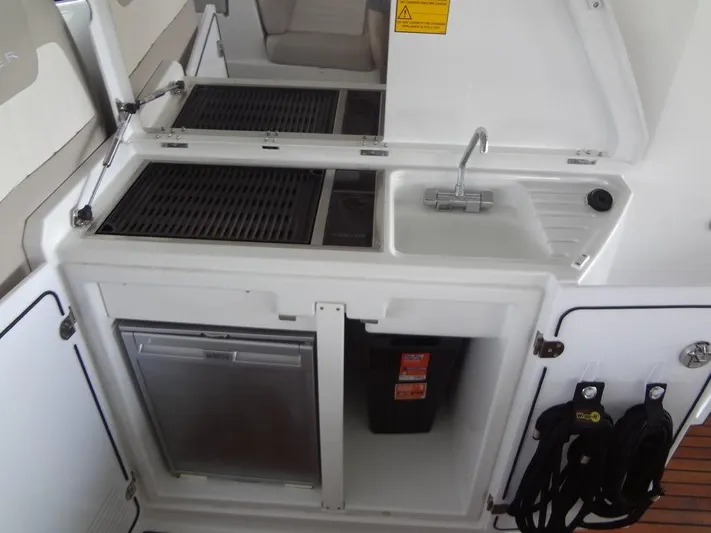 Lake Time, Austin, Tx Yacht Photos Pics Jeanneau LEADER 36 yacht kitchenette with sink, grill, and mini fridge, 2017 model.