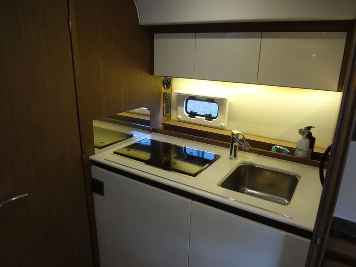 Lake Time, Austin, Tx Yacht Photos Pics 2017 Jeanneau Leader 36 yacht kitchen with stove, sink, and storage cabinets.