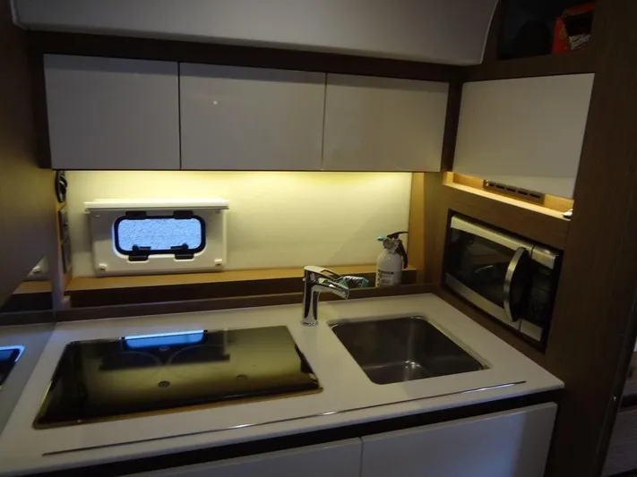 Lake Time, Austin, Tx Yacht Photos Pics Modern kitchen in 2017 Jeanneau Leader 36 yacht with stove, sink, and microwave.