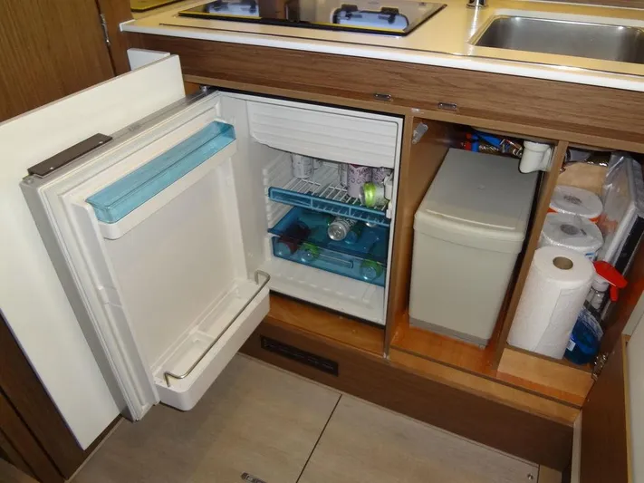 Lake Time, Austin, Tx Yacht Photos Pics Compact kitchen area in a 2017 Jeanneau Leader 36 yacht with open fridge and storage.